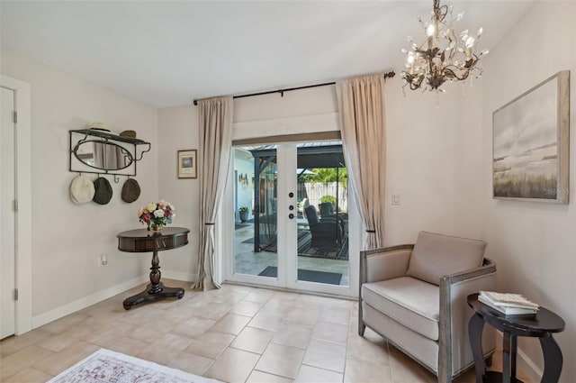 living area with light tile patterned floors, baseboards, a chandelier, and french doors