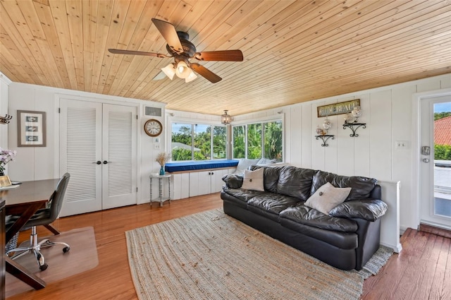 living area with wooden ceiling, wood finished floors, and a healthy amount of sunlight