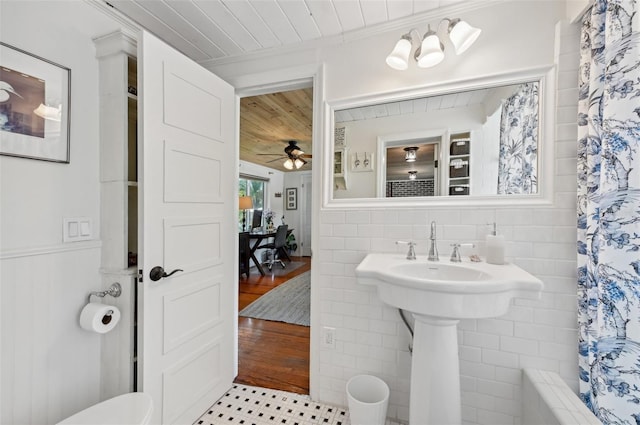 bathroom featuring a wainscoted wall, ceiling fan, and wooden ceiling