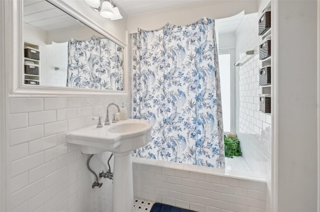 full bathroom featuring tile walls and a shower with shower curtain