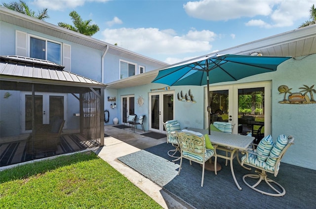 view of patio featuring french doors and outdoor dining area