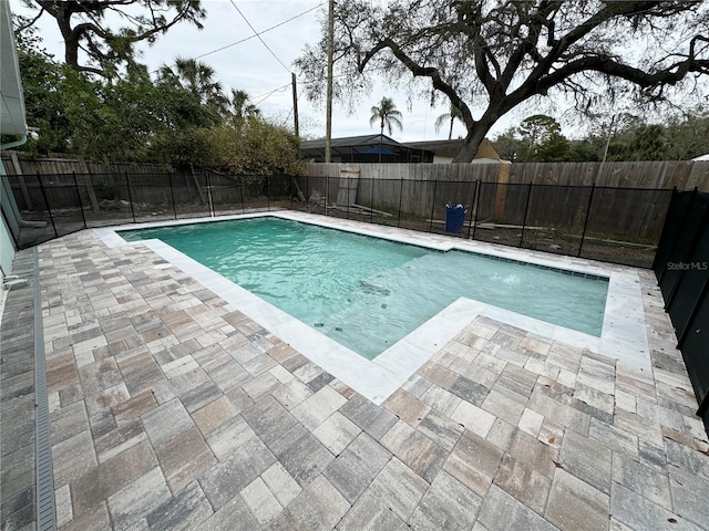 view of swimming pool with a patio area, a fenced backyard, and a fenced in pool