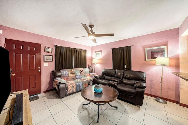 living room featuring a textured ceiling, light tile patterned flooring, and ceiling fan