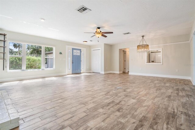 unfurnished living room featuring light wood-type flooring and ceiling fan