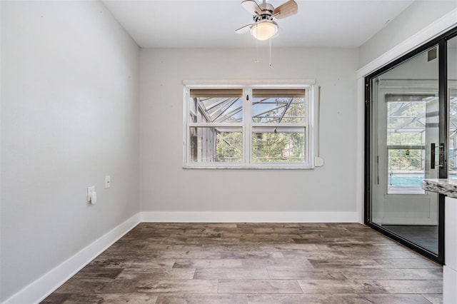 spare room with hardwood / wood-style floors and ceiling fan