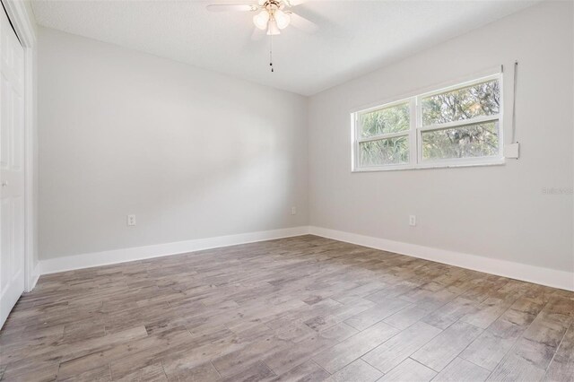 unfurnished room with ceiling fan and light hardwood / wood-style flooring