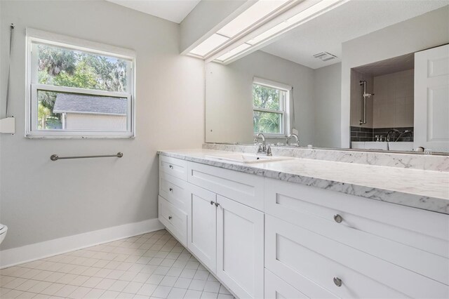 bathroom featuring tile patterned flooring, toilet, and vanity