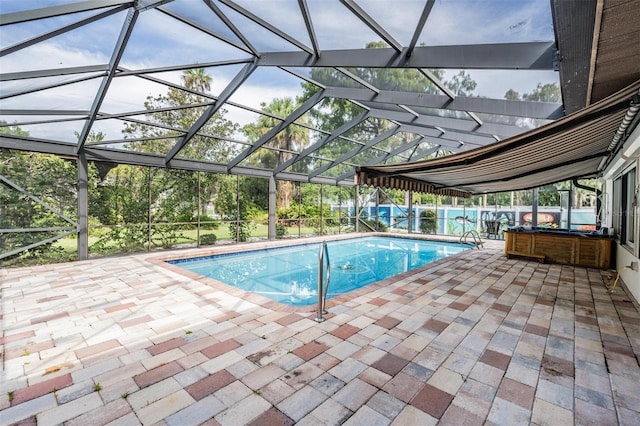 view of pool featuring glass enclosure and a patio