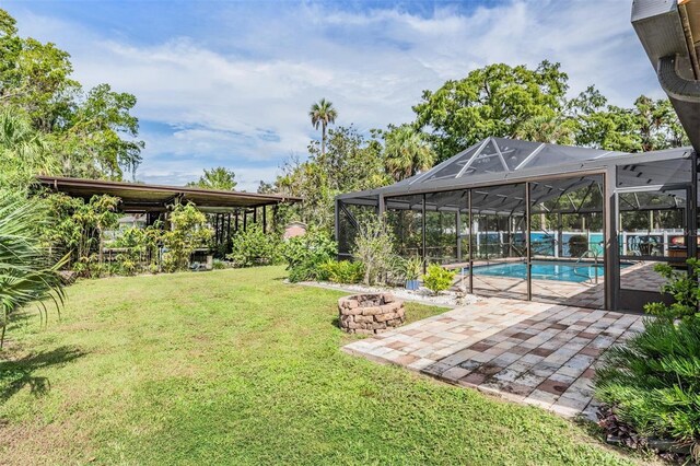 view of yard featuring a patio area and glass enclosure