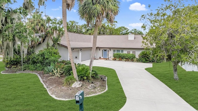 ranch-style house with a front lawn and a garage