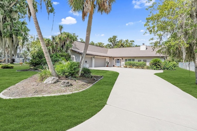 ranch-style home featuring a front yard and a garage