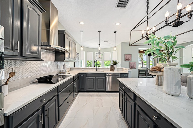 kitchen with wall chimney exhaust hood, stainless steel dishwasher, light stone countertops, and hanging light fixtures