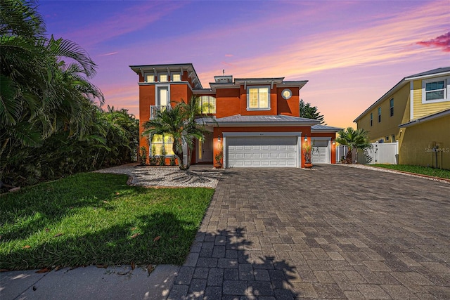 view of front of property with a lawn and a garage