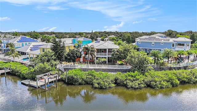 back of property featuring a water view