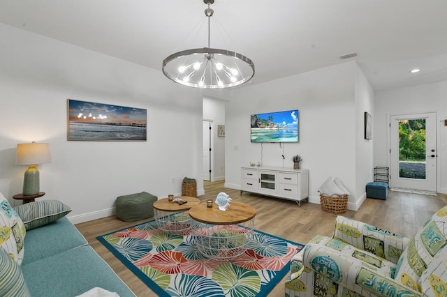 living room featuring hardwood / wood-style floors and an inviting chandelier