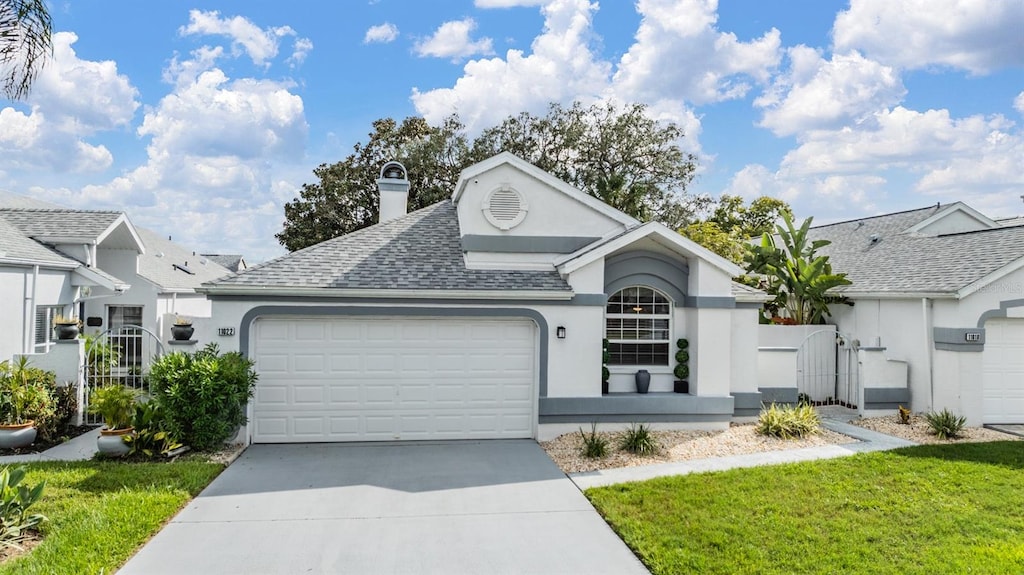 view of front facade featuring a garage and a front lawn