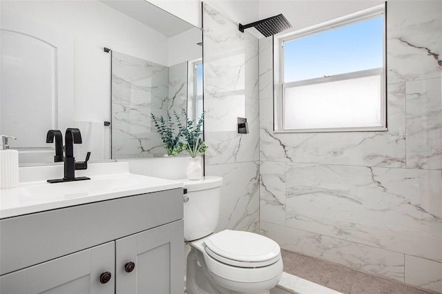 bathroom featuring tiled shower, vanity, toilet, and tile patterned floors