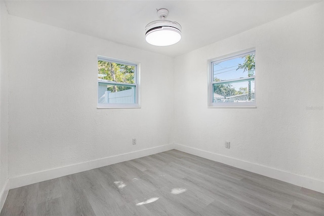 unfurnished room with light hardwood / wood-style floors