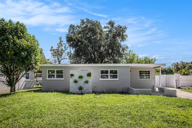 ranch-style home featuring a front yard