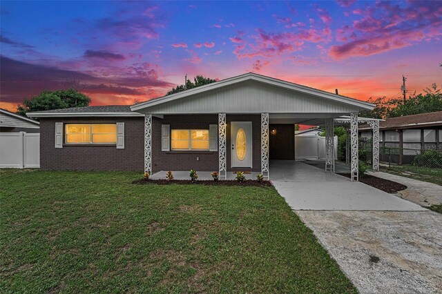 view of front facade featuring a yard and a carport