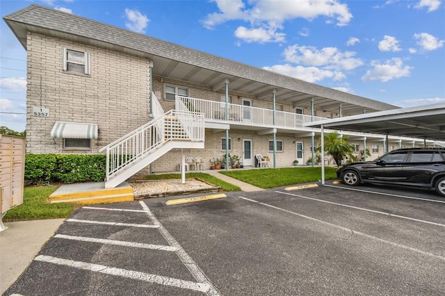 partially covered parking lot featuring stairway