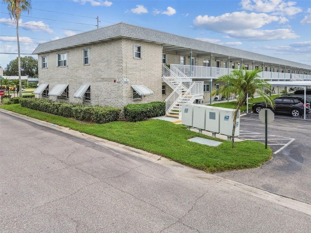 view of property featuring uncovered parking