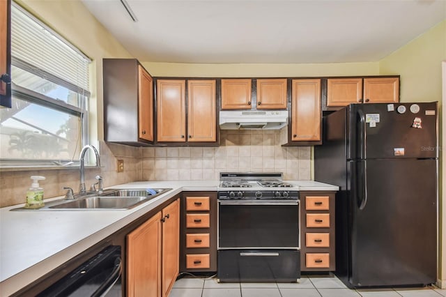 kitchen featuring black appliances, decorative backsplash, sink, and light tile patterned flooring