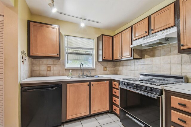 kitchen featuring black appliances, rail lighting, sink, and decorative backsplash