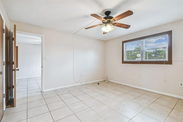 empty room featuring ceiling fan and light tile patterned floors