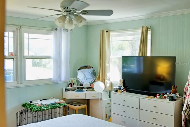 bedroom featuring multiple windows, ceiling fan, and ornamental molding