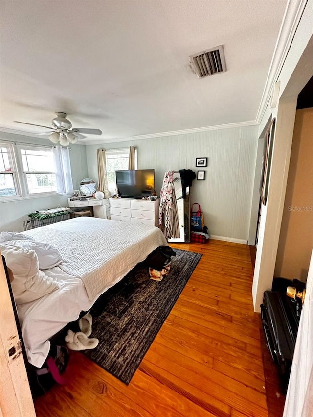 bedroom with hardwood / wood-style floors and ceiling fan