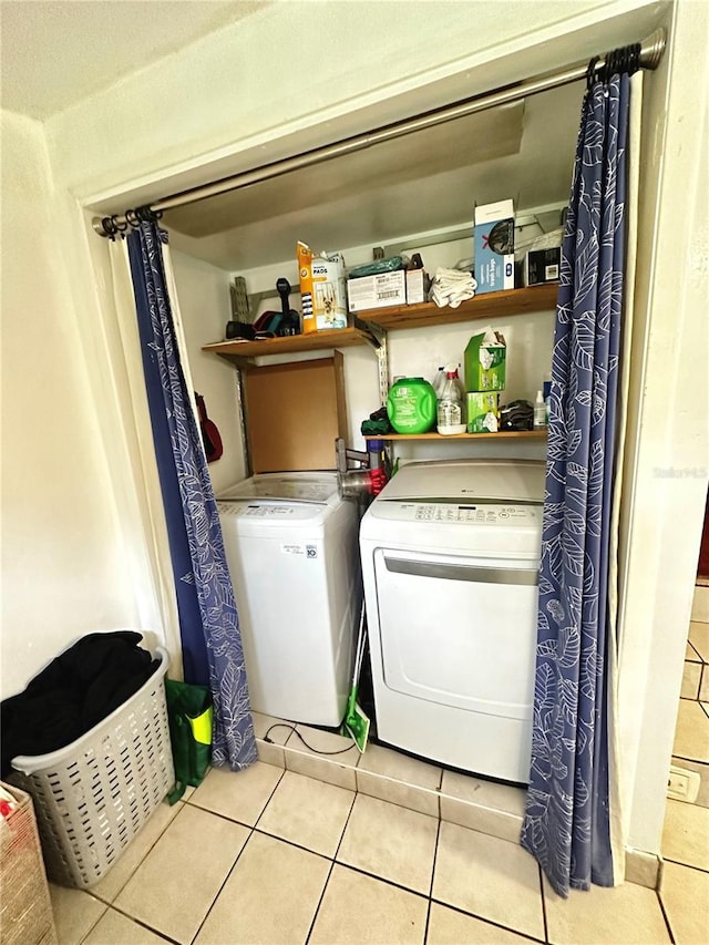 washroom with light tile patterned floors and separate washer and dryer