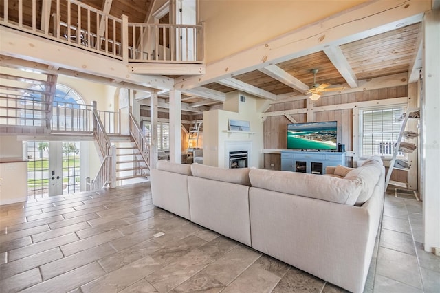 2118 Harbour Watch Dr, Tarpon Springs, FL 34689 - living room featuring ceiling fan, a glass covered fireplace, stairway, a high ceiling, and french doors
