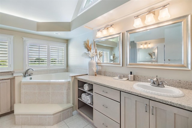 bathroom with vanity, tiled bath, tile patterned flooring, and a healthy amount of sunlight