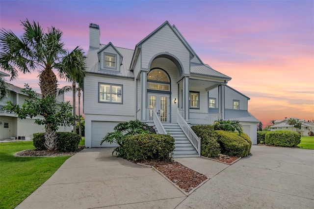 view of front of house with a garage and a porch