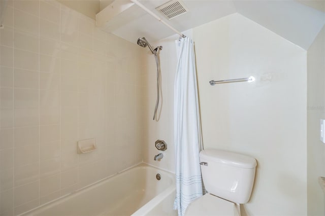 bathroom with toilet, shower / tub combo, and lofted ceiling