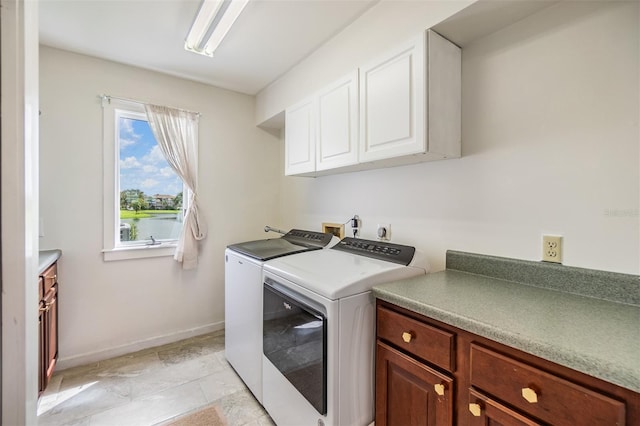 washroom featuring washing machine and dryer and cabinets