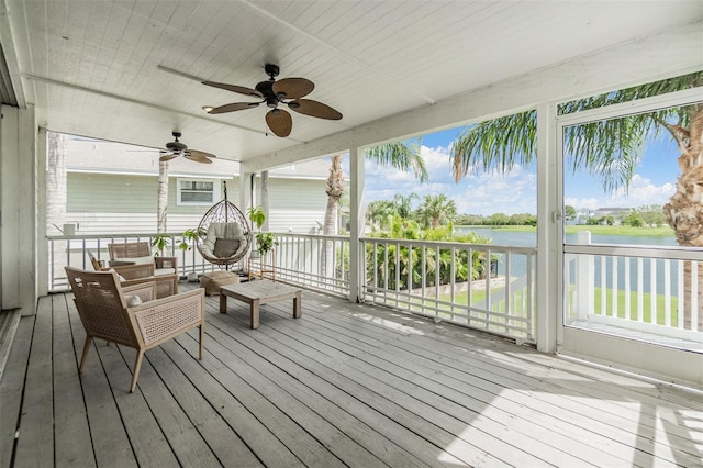 wooden terrace with ceiling fan and a water view