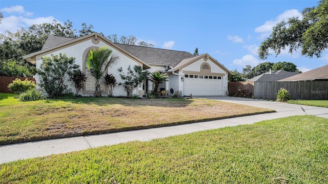 view of front of property featuring a front yard and a garage