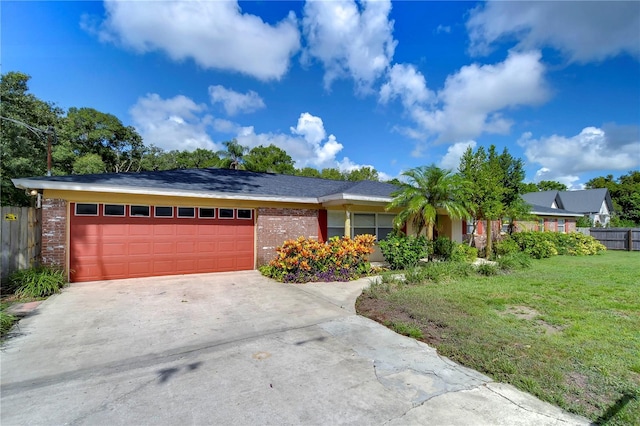 ranch-style home featuring a front yard and a garage