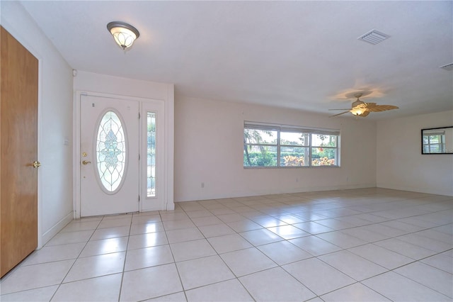 foyer entrance with light tile patterned floors and ceiling fan