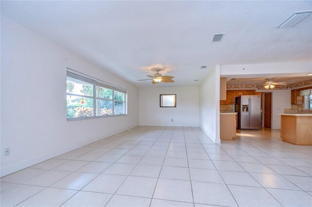 interior space featuring ceiling fan and light tile patterned floors