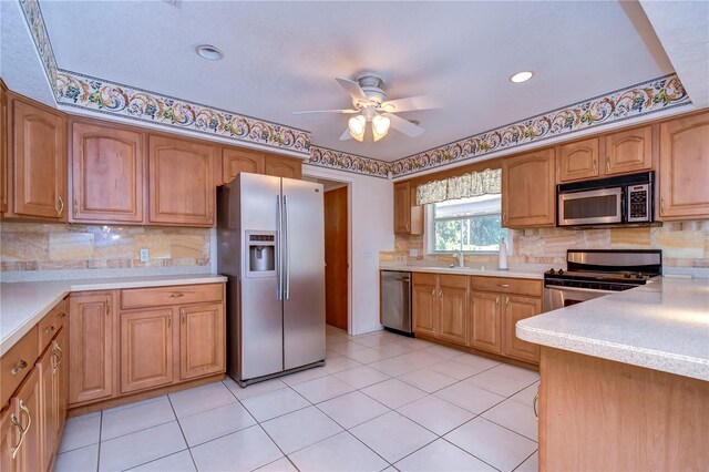 kitchen with ceiling fan, light tile patterned floors, stainless steel appliances, and backsplash