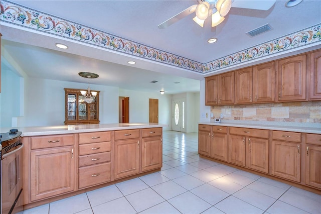 kitchen featuring decorative light fixtures, stainless steel electric range, ceiling fan with notable chandelier, and backsplash