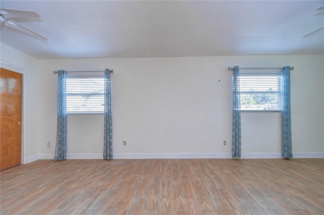 spare room with light wood-type flooring and ceiling fan