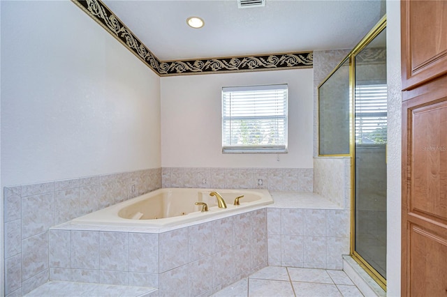 bathroom featuring tile patterned flooring and shower with separate bathtub