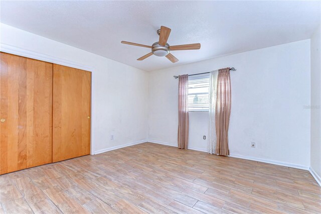 unfurnished bedroom with a closet, ceiling fan, and light hardwood / wood-style flooring