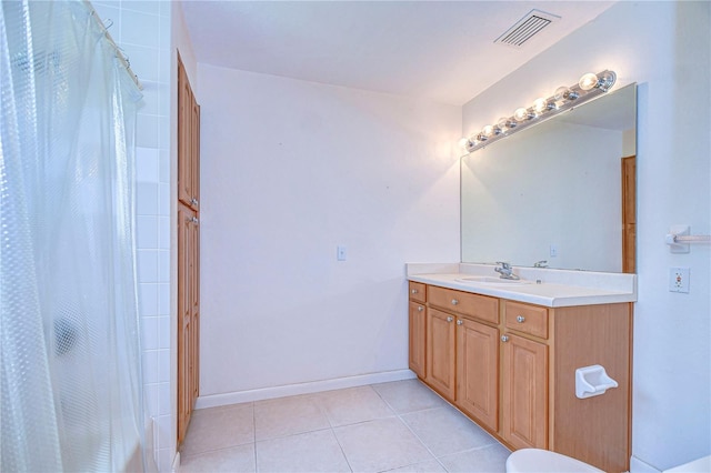 bathroom featuring vanity, toilet, a shower with shower curtain, and tile patterned floors