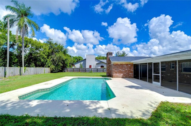 view of pool with a yard and a patio area