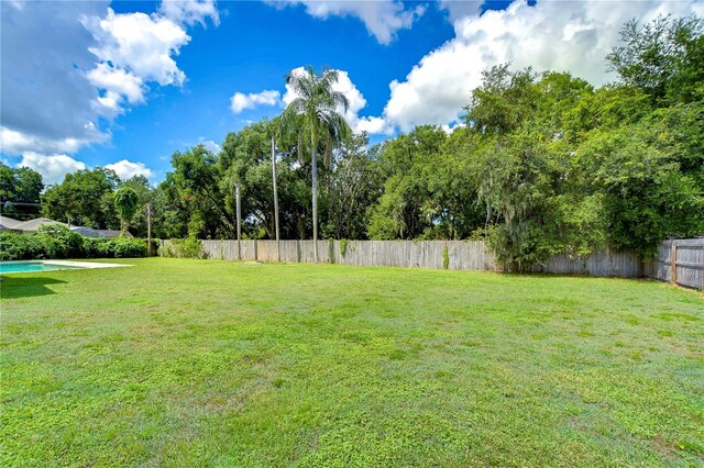 view of yard with a fenced in pool